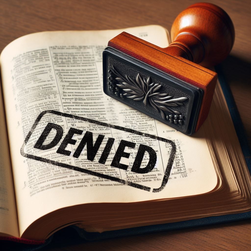 An open Bible stamped with the words “Denied.”