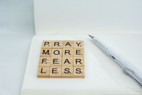 Pray more, fear less spelled in block letters.