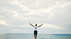 Man with arms outstretched to the sky