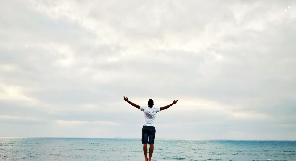 Man with arms outstretched to the sky